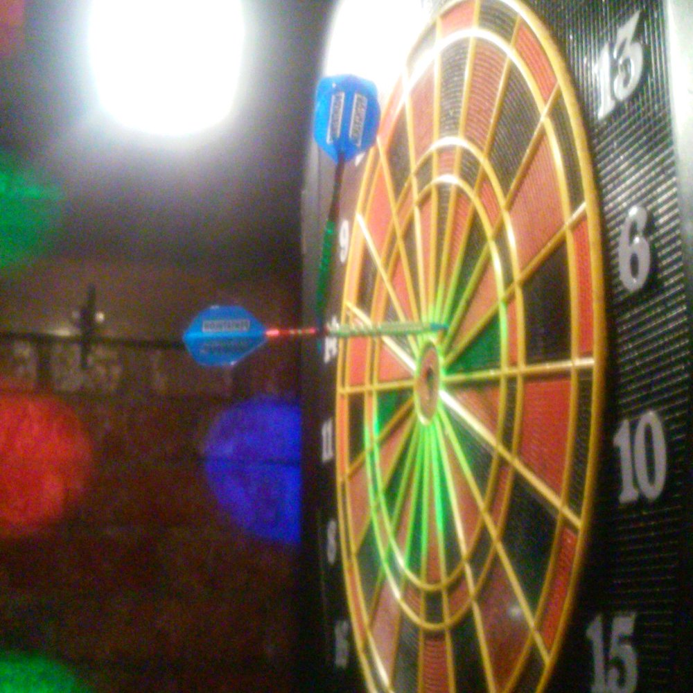 Singers Karaoke Club - a dart in the center of a dartboard - Karaoke Near Me - Syracuse, New York
