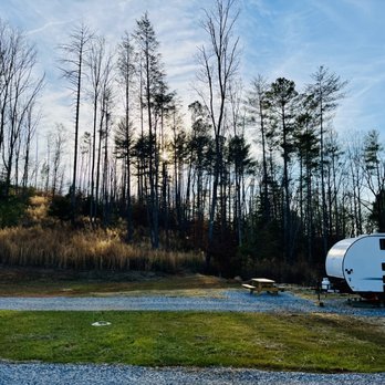 River Pointe RV Park & Campground - Sun is just about to set behind the trees - trails are accessible up this hill to view sunsets and overlooks river below - RV Parks Near Me - Morganton, North Carolina River Pointe RV Park & Campground - Sun is just about to set behind the trees - trails are accessible up this hill to view sunsets and overlooks river below - RV Parks Near Me - Morganton, North Carolina