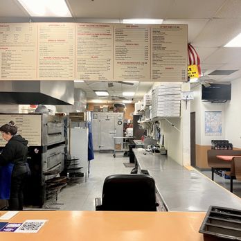Manhattan Pizza - a woman working in the kitchen - Pizza Near Me - Las Vegas, Nevada Manhattan Pizza - a woman working in the kitchen - Pizza Near Me - Las Vegas, Nevada