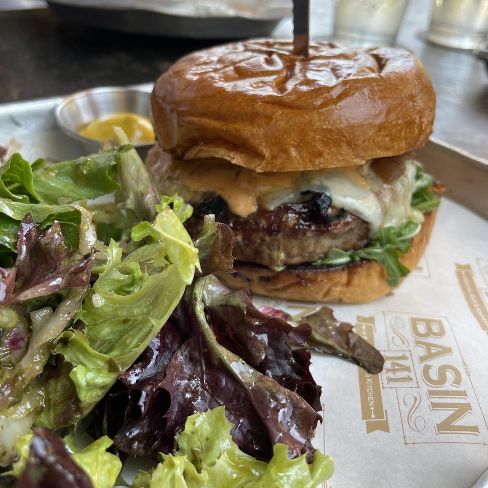 Basin 141 - The house burger! It has Manchego cheese, grilled onions, and arugula plus a thousand-island style dressing on brioche. So, so, good. - Gastropubs Near Me - Monrovia, California Basin 141 - The house burger! It has Manchego cheese, grilled onions, and arugula plus a thousand-island style dressing on brioche. So, so, good. - Gastropubs Near Me - Monrovia, California