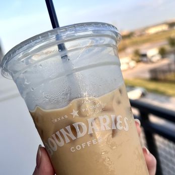 Boundaries coffee - a hand holding a cup of iced coffee - Coffee & Tea Near Me - Aubrey, Texas