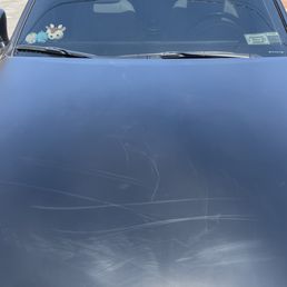 Close up of the hood. You could see the scratches and fingerprints Close up of the hood. You could see the scratches and fingerprints