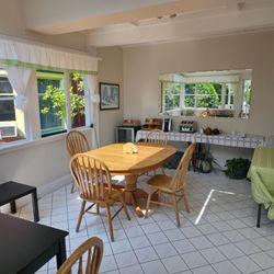 Cambie Lodge - Bright kitchen filled with natural light, offering a welcoming space to enjoy breakfast and relax with garden views.