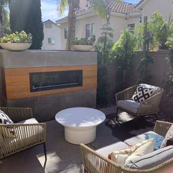 Develoscapes Landscape - Custom concrete fireplace with electric insert. Trimmed out with yellow balau wood. - Landscaping Near Me - Escondido, California