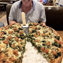 Spinach sausage and cheese pizza