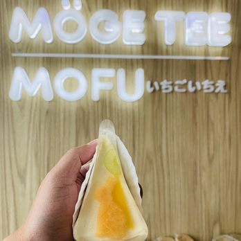 Moge Tee - a hand holding a piece of food - Bubble Tea Near Me - Scarborough, Ontario