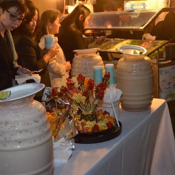 Tijuas Tacos - a woman serving food to a group of people - Caterers Near Me - San Jose, California Tijuas Tacos - a woman serving food to a group of people - Caterers Near Me - San Jose, California