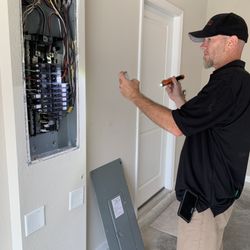 A Buyer’s Choice Home Inspection - Joe on the job, inspecting the inside of electrical panel.