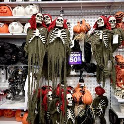 Five Below - Hanging scary skeletons and ghouls.