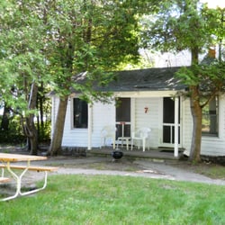 Island View Cottages - Bedroom window looks out at water. Small Weber grill, chairs and picnic table for guests' use.