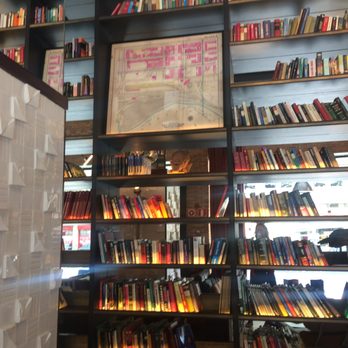 H10 Tribeca - The lobby with bookshelves floor to ceiling - Hotels Near Me - Madrid, M