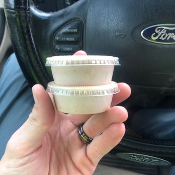 Raising Cane's Chicken Fingers - a hand holding a plastic bowl - Chicken Shop Near Me - Lancaster, Ohio