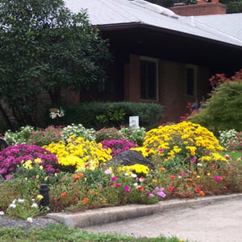 Thomas Landscapes - a flower bed in front of a house - Landscaping Near Me Thomas Landscapes - a flower bed in front of a house - Landscaping Near Me