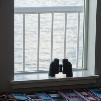 Cannery Pier Hotel & Spa - Paddes seat by the window and binoculars provided by the hotel for checking out the view - Hotels Near Me - Astoria, Oregon Cannery Pier Hotel & Spa - Paddes seat by the window and binoculars provided by the hotel for checking out the view - Hotels Near Me - Astoria, Oregon