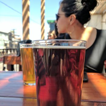 Mamut Cervecería - Brews in the foreground wife in the background. - Beer Bar Near Me - Tijuana, BCN