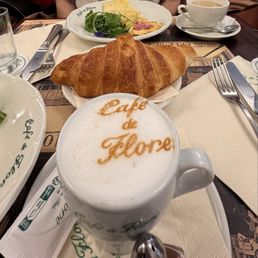 A cappuccino, croissant and omelette .