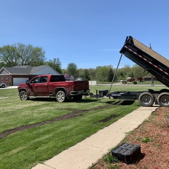 J&S Fencing and Construction - a man loading a dump truck - Fences & Gates Near Me J&S Fencing and Construction - a man loading a dump truck - Fences & Gates Near Me