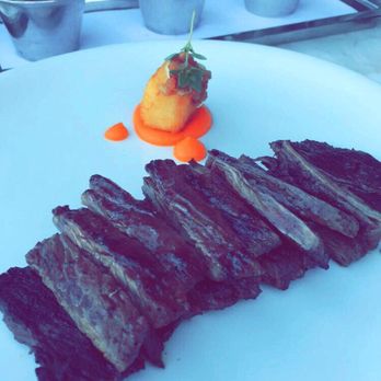 Bourbon Steak - 10 oz. skirt steak w/ potato croquette over a bed of carrot purée and sauce trio - Steakhouses Near Me - Glendale, California