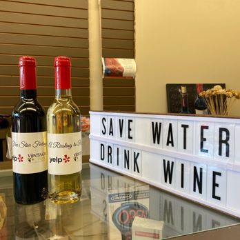 Vintage Vines - two bottles of wine and a sign that says save water drink wine - Wineries Near Me - Mississauga, Ontario Vintage Vines - two bottles of wine and a sign that says save water drink wine - Wineries Near Me - Mississauga, Ontario