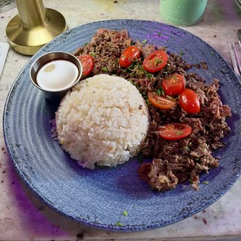 Tiki On 18th - Tapsimatis (marinated shaved beef ribeye over garlic rice with grape tomatoes and chili oil vinegar) - Tiki Bars Near Me - Washington, DC, District of Columbia Tiki On 18th - Tapsimatis (marinated shaved beef ribeye over garlic rice with grape tomatoes and chili oil vinegar) - Tiki Bars Near Me - Washington, DC, District of Columbia