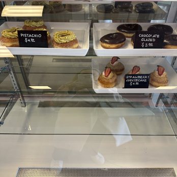 Cafe Rivkah - Pistachio & strawberry shortcake donuts $4.50 ea. Chocolate glazed $3 ea. Selection changes regularly - Bakeries Near Me - Marietta, Georgia