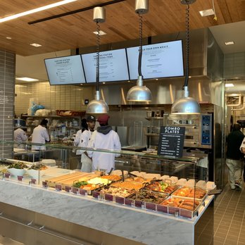 Plum Market - a restaurant kitchen with a counter full of food - Grocery Near Me - Detroit, Michigan Plum Market - a restaurant kitchen with a counter full of food - Grocery Near Me - Detroit, Michigan
