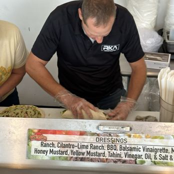 Wriggles - The owner, neatly rolling up our Turkey Bacon Wraps. - Delis Near Me - Murray, Utah Wriggles - The owner, neatly rolling up our Turkey Bacon Wraps. - Delis Near Me - Murray, Utah