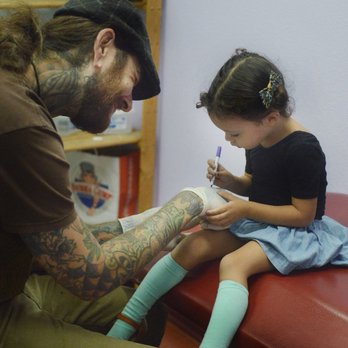 Kathouse Tattoo - Getting comfortable, drawing on Nicholas' gloves - Piercing Near Me - Northridge, California