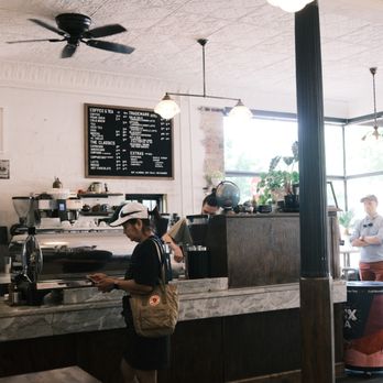 Spyhouse Coffee Roasters - a man standing at the counter - Coffee Roasteries Near Me - Saint Paul, Minnesota