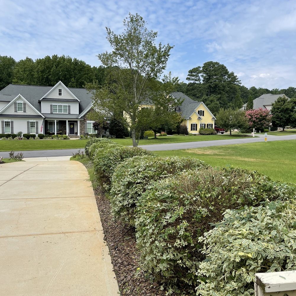 Oak City Lawn Care Service - a home in the background - Lawn Services Near Me Oak City Lawn Care Service - a home in the background - Lawn Services Near Me