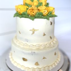 Sugared Bake Shop - A simple two tier lemon velvet birthday cake topped with yellow tulips.