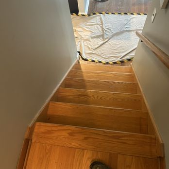 G Restoration Services - a person standing on a set of stairs - Flooring Near Me