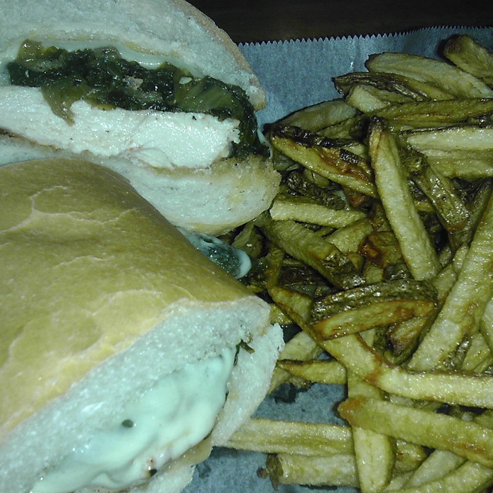 Niki'z Pub - Chicken & greens sandwich (grilled chicken breast, Italian fried greens, provolone), with a side of fries. - Pubs Near Me - Niles, Ohio Niki'z Pub - Chicken & greens sandwich (grilled chicken breast, Italian fried greens, provolone), with a side of fries. - Pubs Near Me - Niles, Ohio