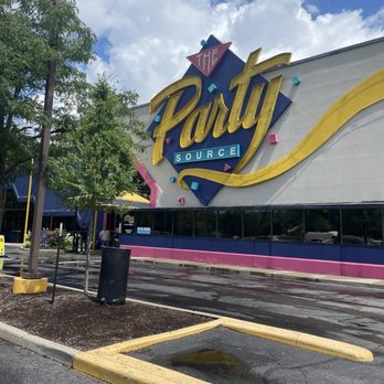 The Party Source - The Party Source store's exterior features a large, colorful sign with the store's name, surrounded by trees and a parking lot. - Tobacco Shops Near Me - Bellevue, Kentucky