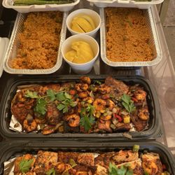 Grill Master - Salmon platter topped with 24 shrimp, green, bell peppers, sweet onions and cilantro, sliced lemon wedges, Mexican rice, and asparagus
