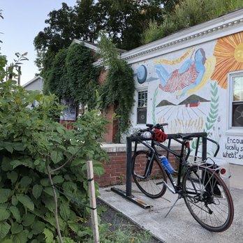 Hungry Ghost Bread - Outside. Out front patio, bike rack, and seating amongst the plants. - Bakeries Near Me - Northampton, Massachusetts Hungry Ghost Bread - Outside. Out front patio, bike rack, and seating amongst the plants. - Bakeries Near Me - Northampton, Massachusetts