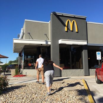 McDonald's - a man and a woman walking in front of a mcdonald's - Burgers Near Me - Bridgman, Michigan McDonald's - a man and a woman walking in front of a mcdonald's - Burgers Near Me - Bridgman, Michigan