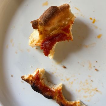 Chicago Pizza Kitchen - a half eaten pizza on a plate - Pizza Near Me - Albuquerque, New Mexico