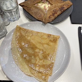Les Galandines - In the front the butter, lemon and sugar crepe. In the back or the top is the buckwheat savory, potato, bacon and cheese crepe. - Creperies Near Me - Paris, 75