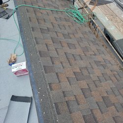 Redwood Roofing - Installing new shingles over the roof.