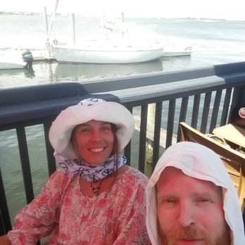 Bungalow Bar - Sitting on the deck, our sailboat in the background. - American Near Me - Seaside, New York Bungalow Bar - Sitting on the deck, our sailboat in the background. - American Near Me - Seaside, New York