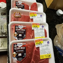 a variety of steaks in plastic containers