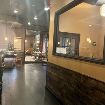 Ember & Cork - A restaurant interior with tables, chairs, and warm lighting, featuring a mix of modern and rustic decor elements. - Seafood Near Me - Schenectady, New York