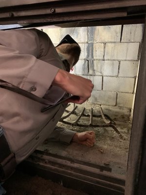 Photo of Comprehensive Property Inspection - Clinton Township, MI, US. Checking on the interior of a chimney is a very dirty job, but it has to be done for a comprehensive inspection.