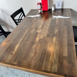 Milestone Craft Deli - Tables looked like this - all crumbs everywhere we had to wipe them down to dine in and eat...