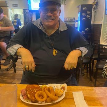 Roscoe's Pub and Grill - a man cutting a plate of food - Pubs Near Me - Hudson, Florida Roscoe's Pub and Grill - a man cutting a plate of food - Pubs Near Me - Hudson, Florida