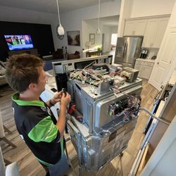 Duncan Home Services - Justin repairing a oven
