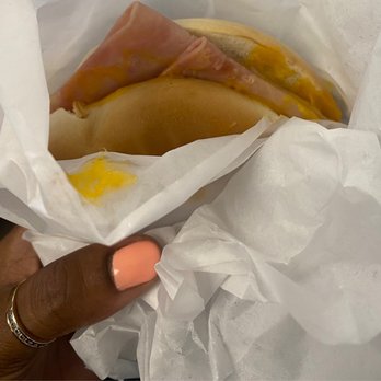 Guava and Java - a hand holding a sandwich wrapped in wax paper - Coffee & Tea Near Me - Miami, Florida Guava and Java - a hand holding a sandwich wrapped in wax paper - Coffee & Tea Near Me - Miami, Florida
