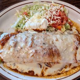 FAJITA BURRITO: chicken or steak, with beans, sauteed tomatoes, onions, peppers, topped with red sauce and cheese dip. FAJITA BURRITO: chicken or steak, with beans, sauteed tomatoes, onions, peppers, topped with red sauce and cheese dip.