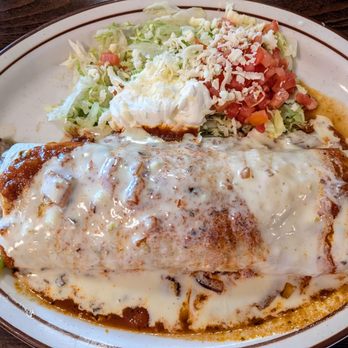 Casa Fiesta Fultondale - FAJITA BURRITO: chicken or steak, with beans, sauteed tomatoes, onions, peppers, topped with red sauce and cheese dip. - Mexican Near Me - Fultondale, Alabama Casa Fiesta Fultondale - FAJITA BURRITO: chicken or steak, with beans, sauteed tomatoes, onions, peppers, topped with red sauce and cheese dip. - Mexican Near Me - Fultondale, Alabama